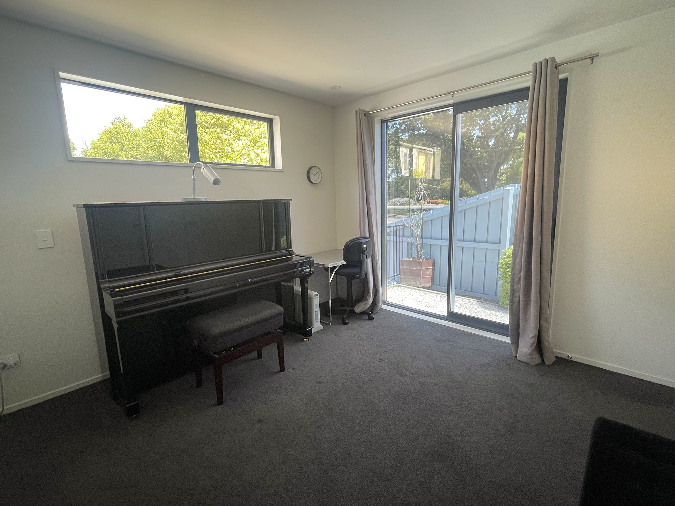 Practice and teaching studio with upright piano and natural light