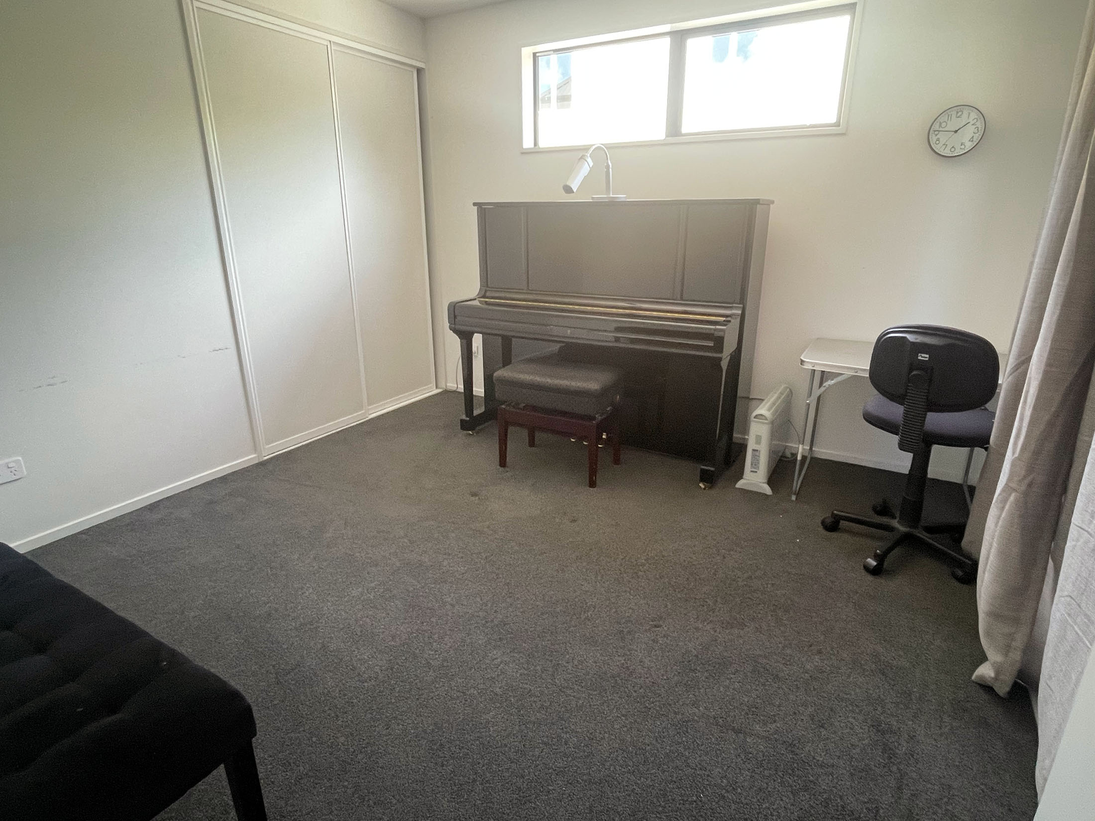 Spacious private music teaching room with piano